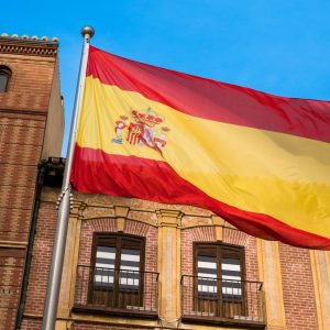 a flag flying in front of a building